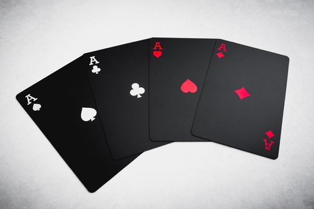 Four black colored aces on table. Playing cards.の写真素材