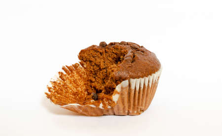 a chocolate chip corn muffin, half bitten, isolated on a white backgroundの写真素材