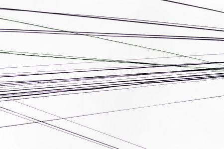 electric wires in front of a white sky, in the city looking up. wallpaper.の写真素材