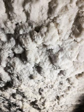 Fluffy white salt deposits on the ceiling of Salina Turda salt mine with lights shining from the side. Cluj, Romaniaの写真素材