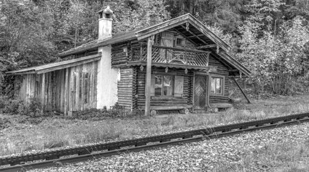 Old wooden shed with chimney by the railroad trackの写真素材
