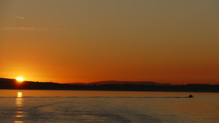 Sunset on Lake Constance with a motorboatの写真素材