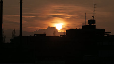 Sunset over industrial building on winter eveningの写真素材