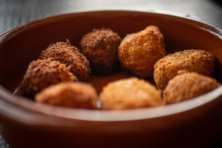 Cheese croquettes in a clay panの写真素材