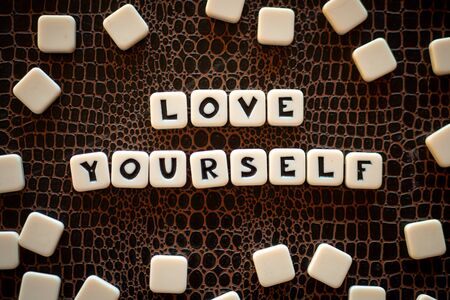 Crossword game pieces forming the phrase "Love yourself"の写真素材