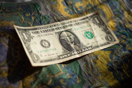 One dollar bill over green clothの写真素材