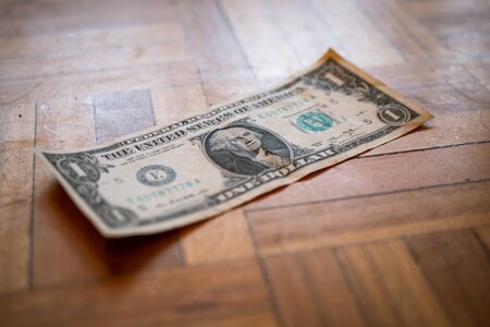 One dollar bill on the floorの写真素材