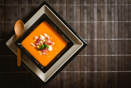 Typical spanish recipe for cordovan salmorejo in a square plate with some ingredients aroundの写真素材
