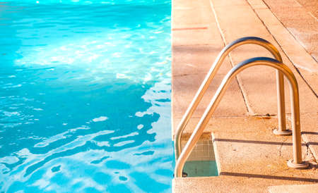 Metal stairs of a salt water pool on a summer day.