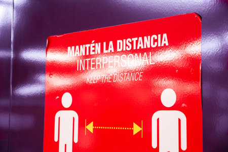 Sticker with instructions to keep social distancing in the Madrid subway (Metro de Madrid) corridors, to prevent coronavirus infections.のeditorial素材
