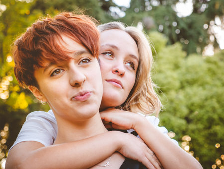 Girls couple in love hugging in a park on a sunny day.の写真素材