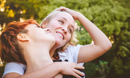 Girls couple in love hugging in a park on a sunny day.の写真素材