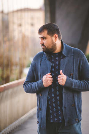 Mature bearded guy posing on a Madrid Bridge at sunset.の写真素材