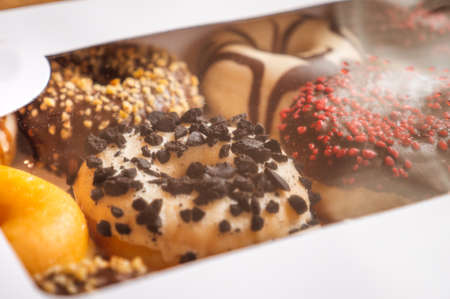 Assortment of donuts of different flavors in a box.の写真素材