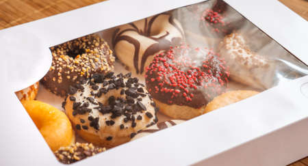 Assortment of donuts of different flavors in a box.の写真素材