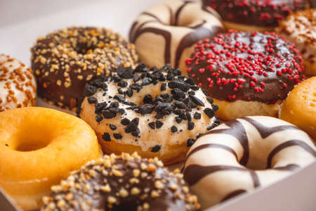 Assortment of donuts of different flavors in a box.の写真素材
