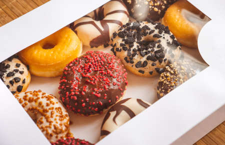 Assortment of donuts of different flavors in a box.の写真素材