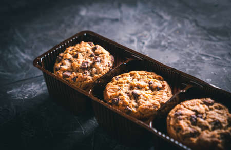 Open chocolate chip cookies package on a dark table. Ready to eat.の写真素材