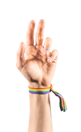 Raised arm wearing a bracelet with the colors of the LGBT flag. LGBT symbol.の写真素材