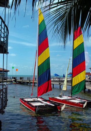 Two colorful sailing boats ready to sail in the oceanの写真素材