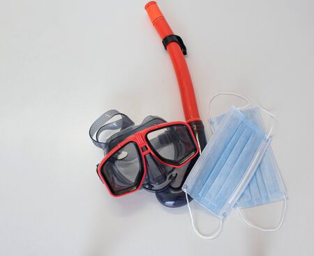 Goggles and snorkel together with white-bottom masks ready to enjoy in the sea. Summer conceptの写真素材