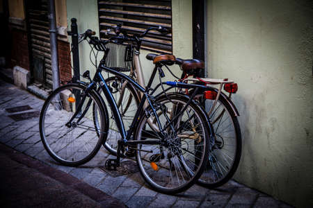 Two Bikes, One Street. A couple of bicycles are parked on the street. They are modern but classic style bikes.のeditorial素材