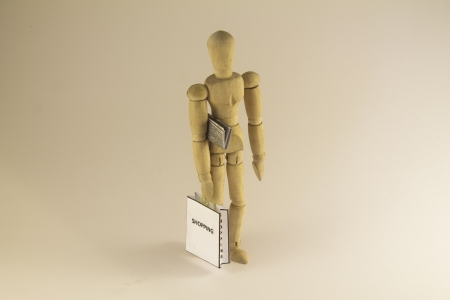 Dummyshopping with a bag and a newspaperの写真素材