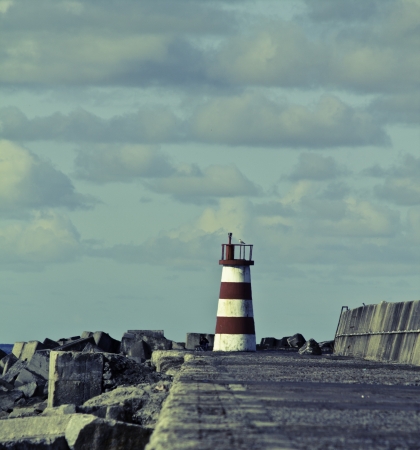 Lighthouse isolated at the end of the pierの写真素材