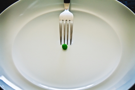 Pea on a white dish with a fork on itの写真素材