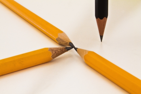 Lots of orange pencils and one black pencil