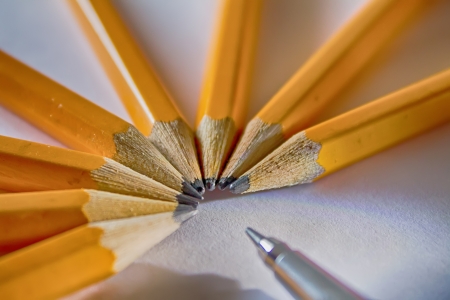 Orange graphite pencils in semi circle with pencil-case in frontの写真素材