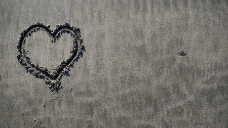 Heart draw on sand on a summer dayの写真素材
