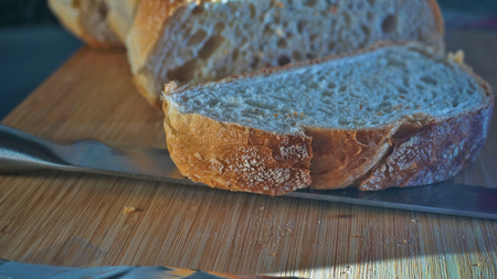 view from sliced bread with knife on a wood table