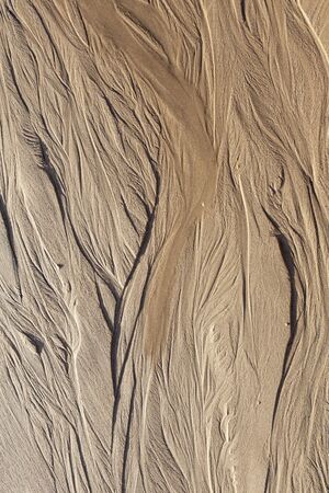 Brands made by water flowing through the sand of the beach.の写真素材