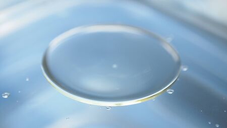 The sky reflected in the water surface macro background wallpaper clean water water bubbles and circles water dropsの写真素材