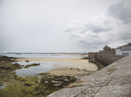 view of the shore from saint malo on a cloudy dayの写真素材