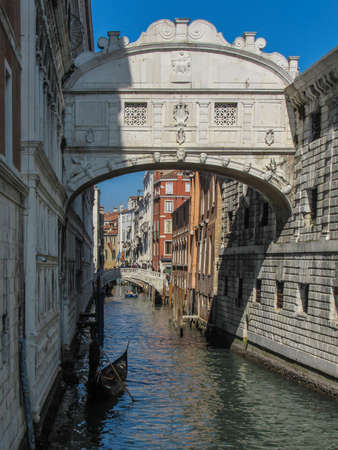Venice, Italy, February 28, 2019: Gondola below an arch in the canals of Veniceのeditorial素材