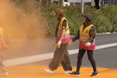 Madrid, Spain, Athletes running in a race with colored powders through the streets of Madrid against violenceのeditorial素材