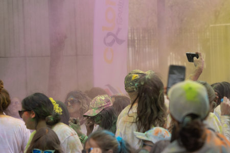 Madrid, Spain, Athletes running in a race with colored powders through the streets of Madrid against...