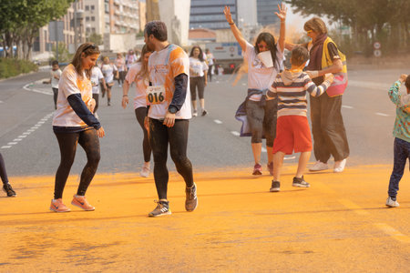 Madrid, Spain, Athletes running in a race with colored powders through the streets of Madrid against violenceのeditorial素材