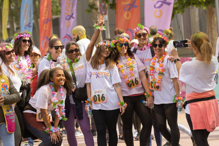 Madrid, Spain, Athletes running in a race with colored powders through the streets of Madrid against...