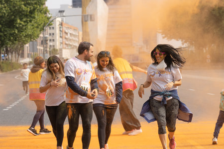 Madrid, Spain, Athletes running in a race with colored powders through the streets of Madrid against...