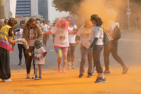 Madrid, Spain, Athletes running in a race with colored powders through the streets of Madrid against...
