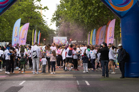 Madrid, Spain, Athletes running in a race with colored powders through the streets of Madrid against...