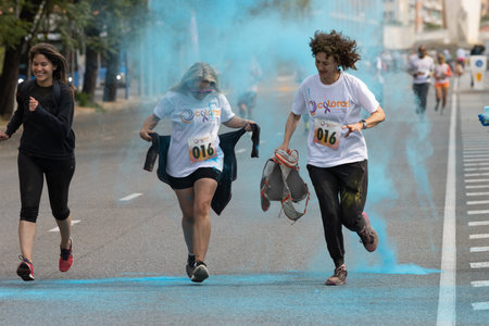 Madrid, Spain, Athletes running in a race with colored powders through the streets of Madrid of...