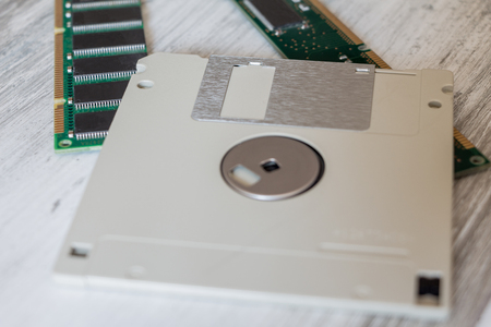 Gray floppy disk and 2 green computer random access memory (RAM) modulesの写真素材