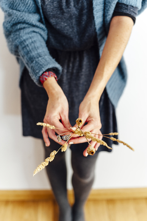 Dry flowers christmas decoration, closeup of a woman holding dry flowersの写真素材