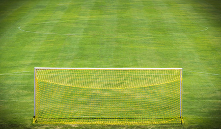 Yellow goal net on green soccer fieldの写真素材