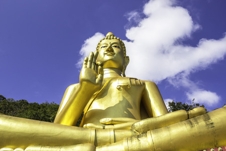 Big gloden Buddah statue with blue sky backgroundの写真素材