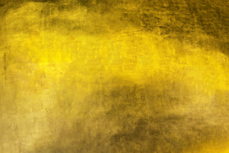 Closeup texture of golden background with reflection lightの写真素材